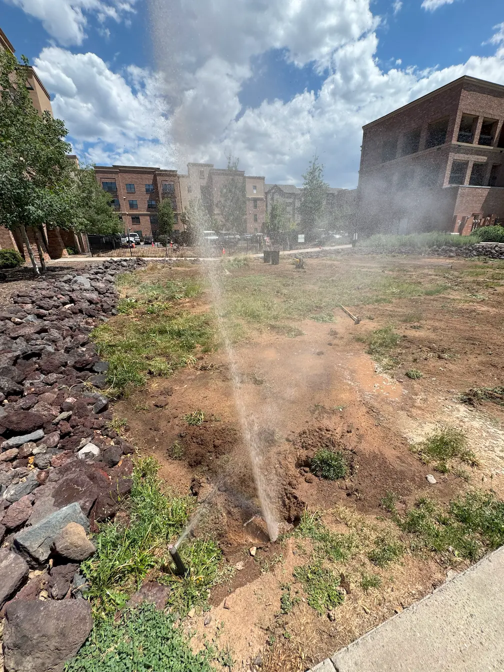 Ponderosa Pathways crew performing spring landscaping cleanup and irrigation startup in Flagstaff