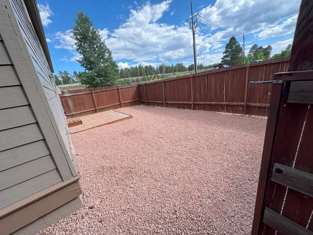 Xeriscaped Flagstaff landscaping project with gravel, clean borders, and a re-set paver path in University Heights.