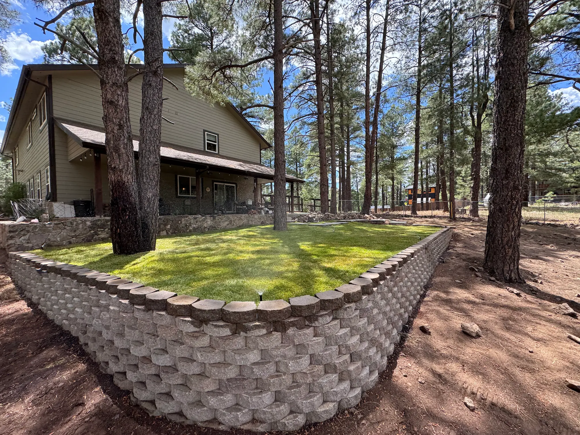 After landscaping — level grass lawn installed by Ponderosa Pathways in Flagstaff